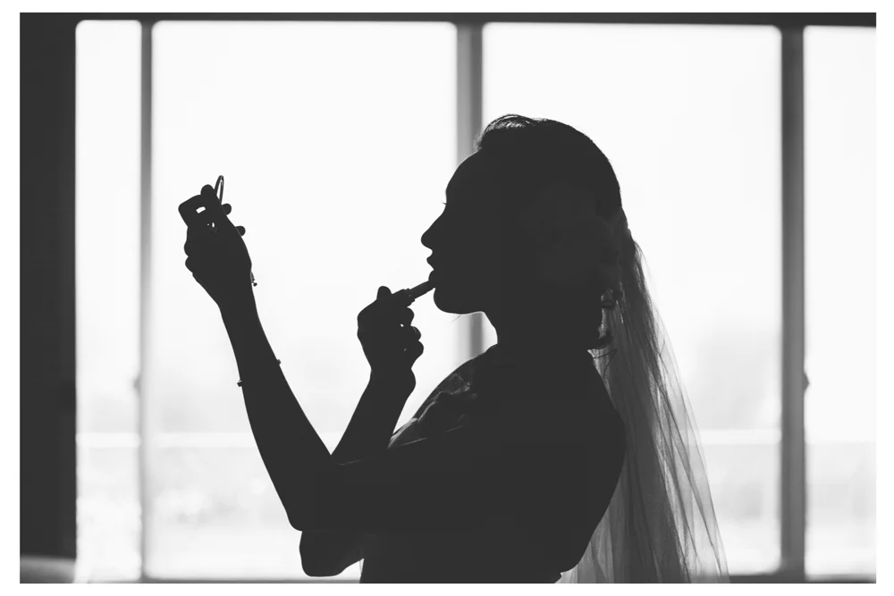 Applying make up at St. Regis Princeville Kauai for a Hawaii wedding.