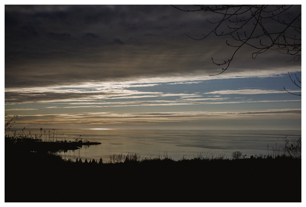 Sun rising over lake Ontario at Scarborough Bluffs Park.