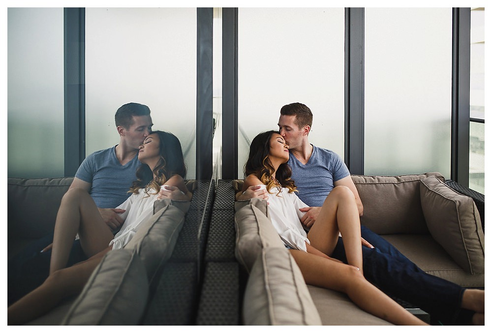 True love is reflected in the groom's kiss up high in the condo. 