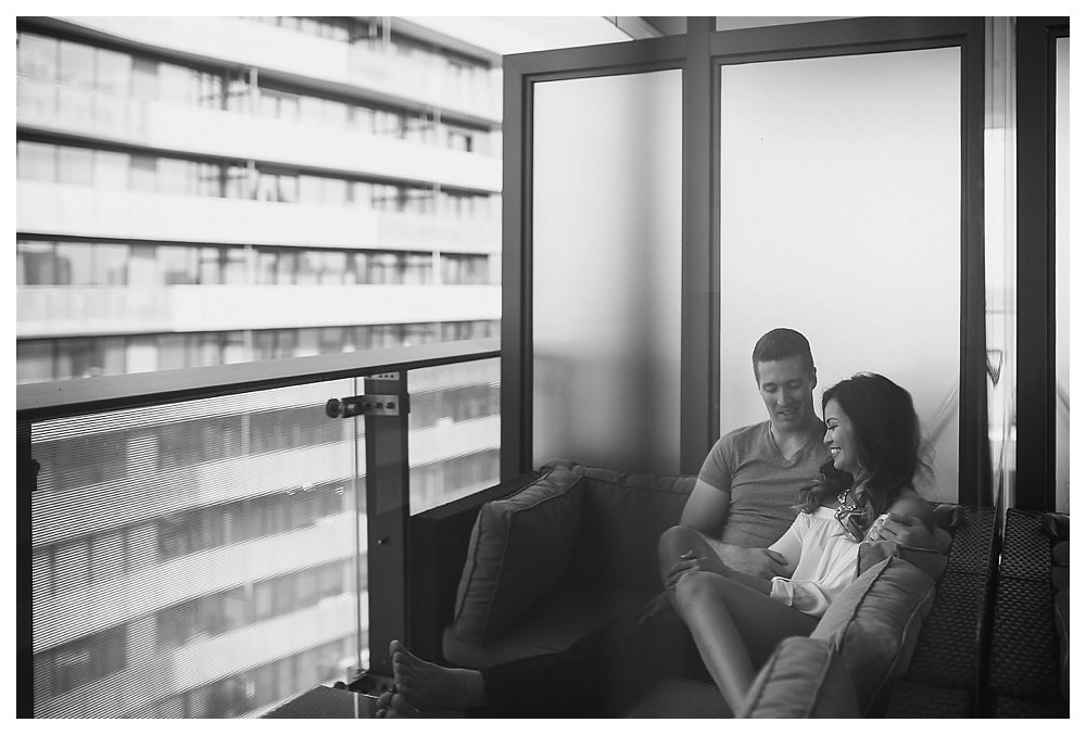 Engagement photos in Toronto begin in the comfort of the home high up on the balcony of their love. 