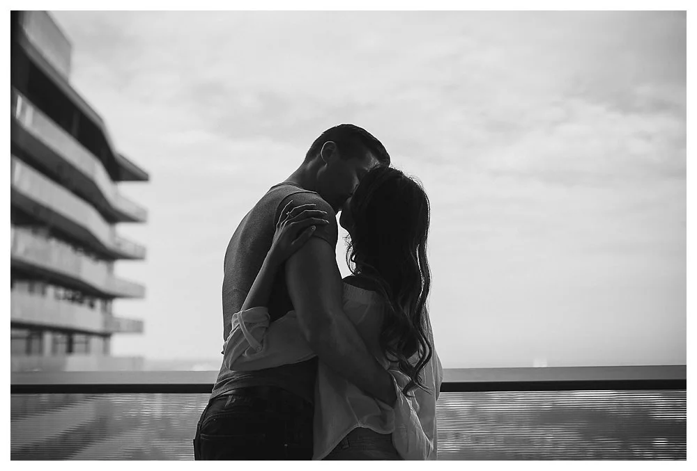 Sealed with a kiss with the city of Toronto below them. 