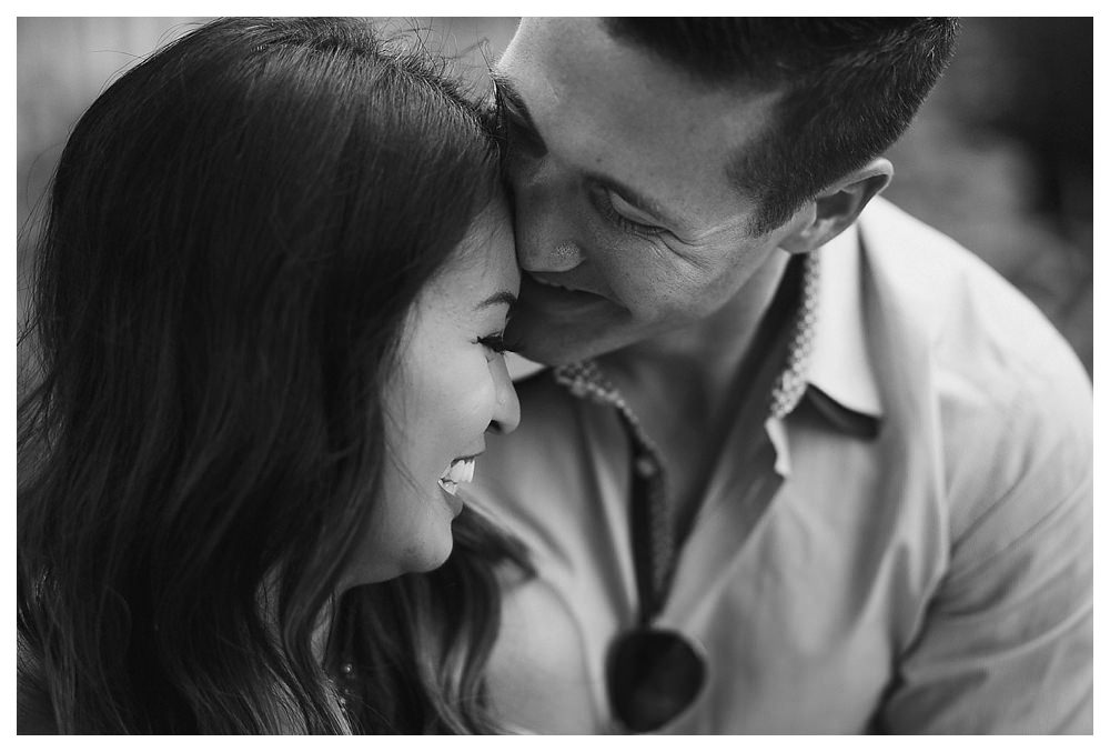 Black and white engagement photos capture the love of the bride and groom. 