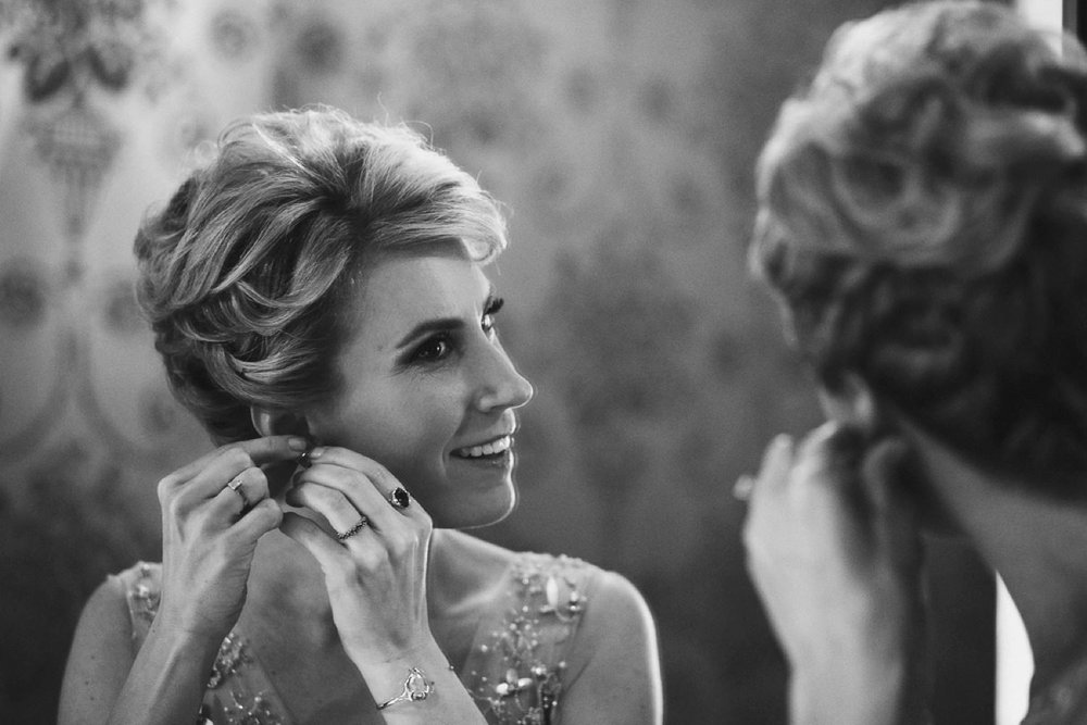 Bride putting earrings on at The Ivy in Toronto.