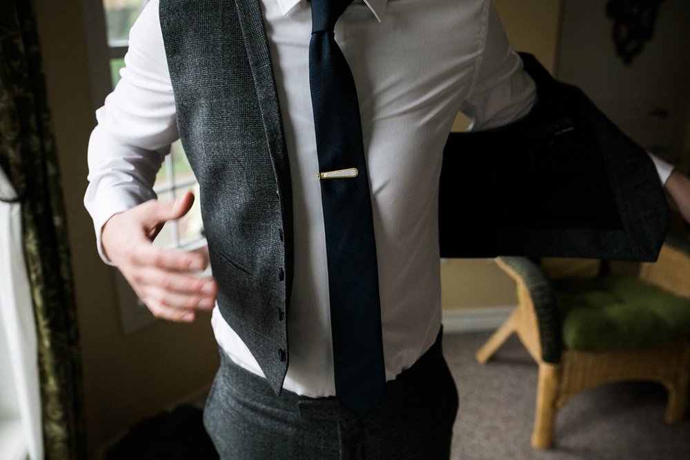 Groom getting dressed for Niagara wedding.