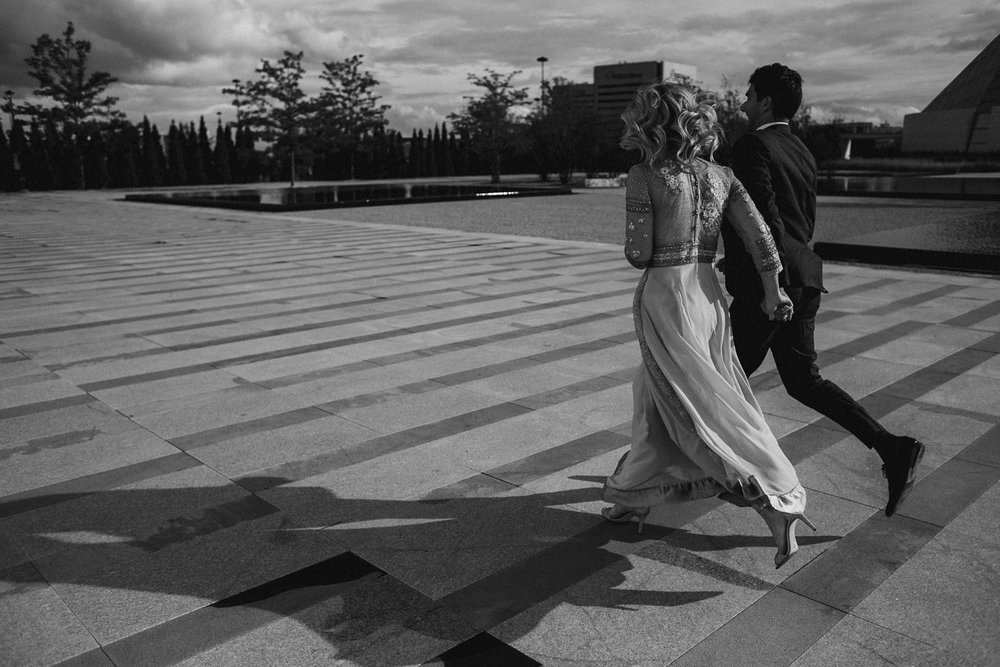 Couple running at Aga Khan engagement photos.