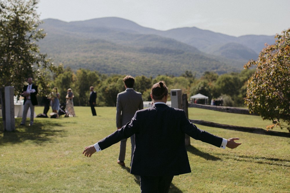 Groom entering ceremony meadow at Trapp Family Lodge wedding.