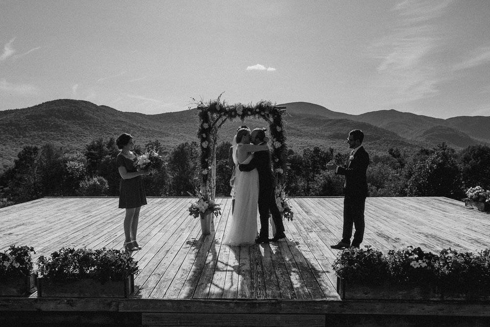 Couple kiss during ceremony in Vermont wedding.