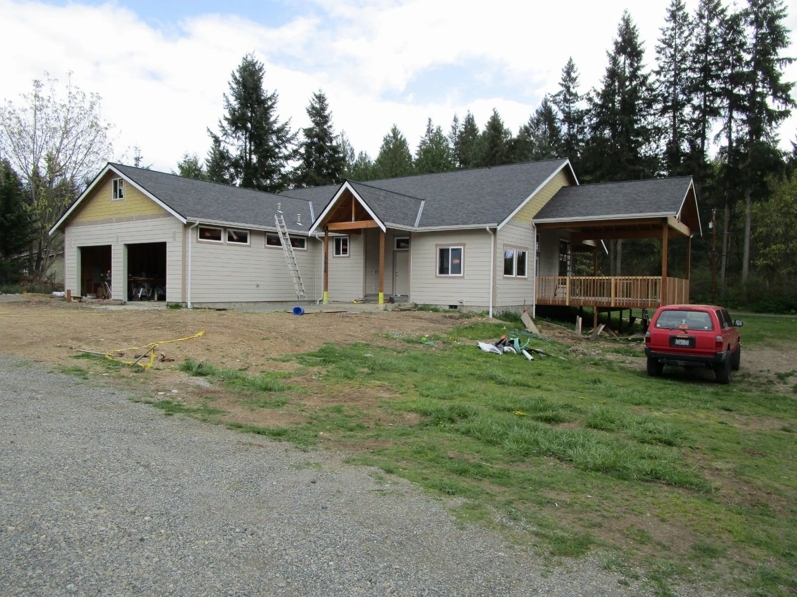 Roofing on, siding being installed.