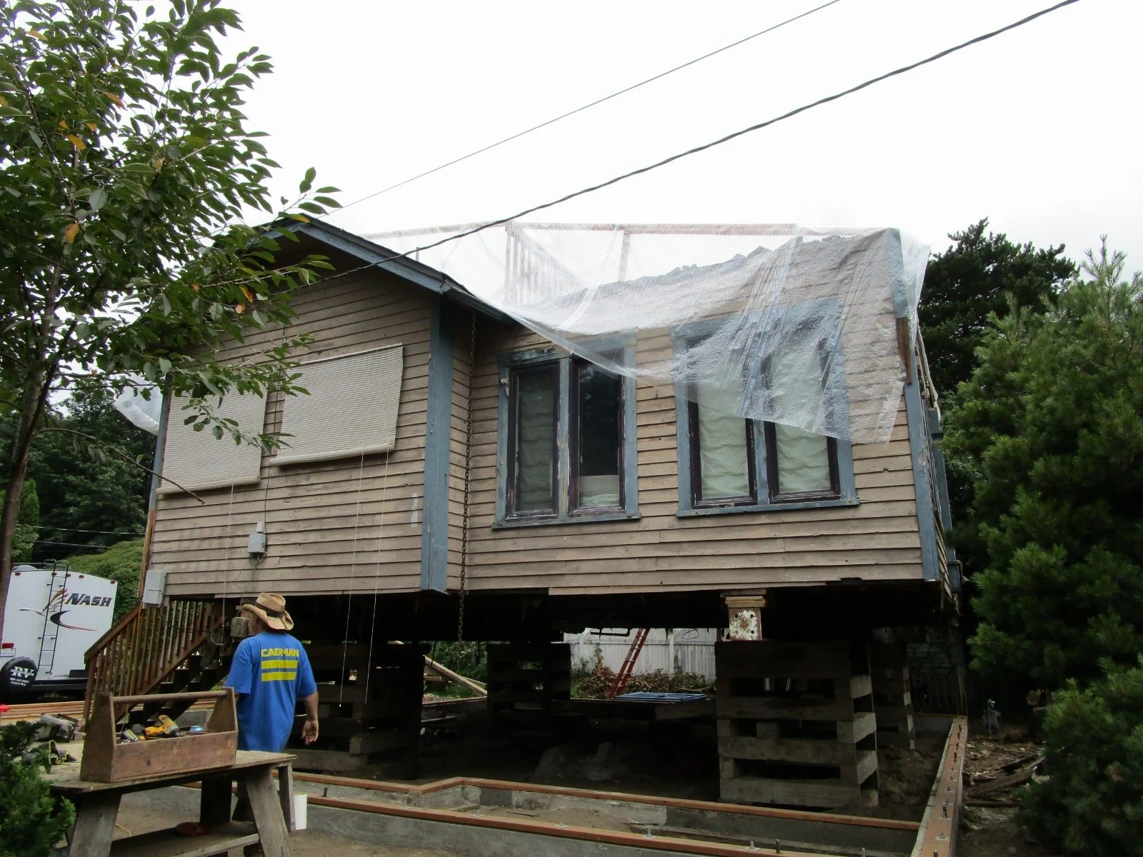 Existing roof is off, a couple of rooms are being saved, so tarping the house.