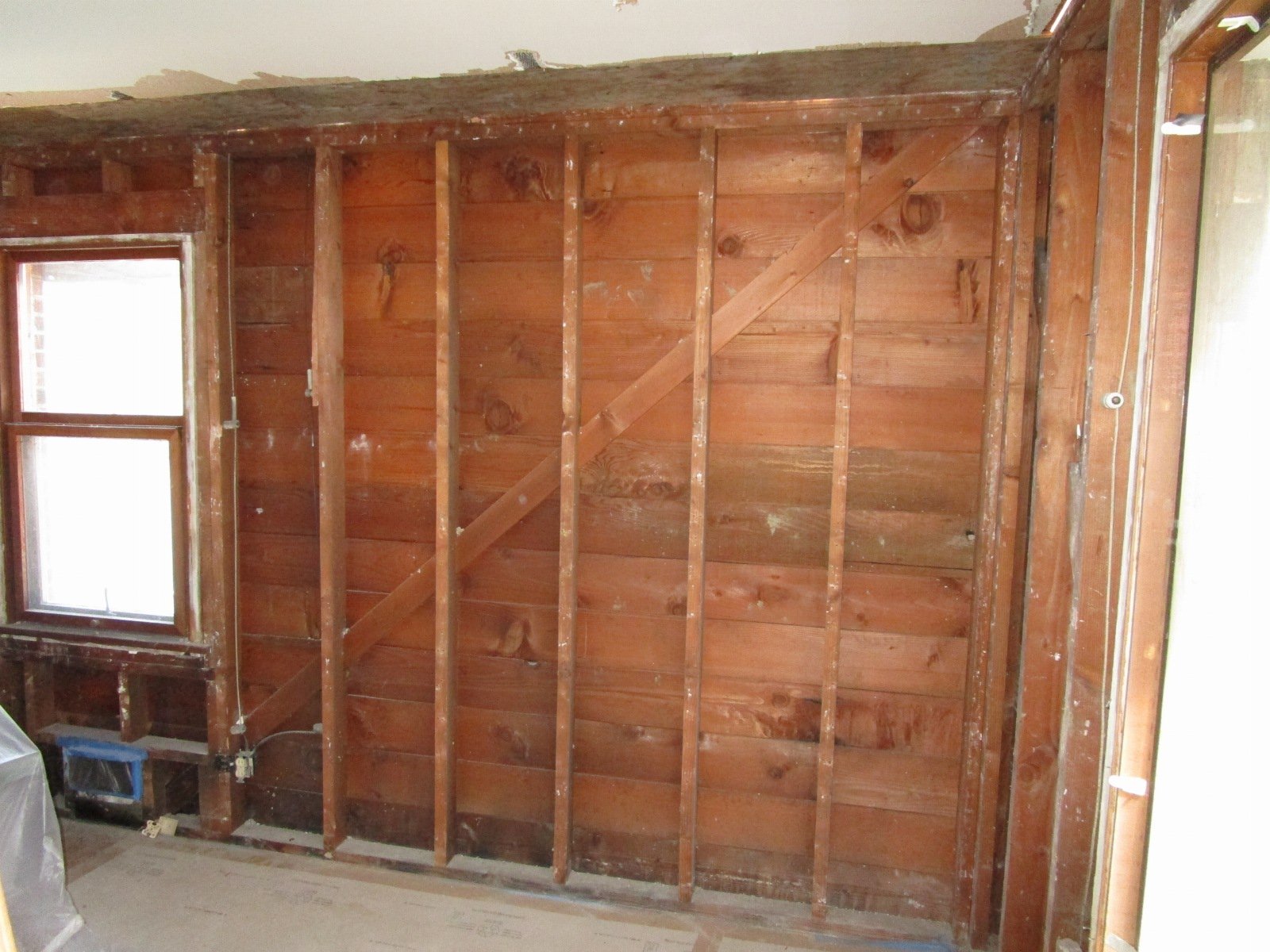 Due to the brick on the outside of the existing walls, the interior sides will receive plywood to help with lateral strength.