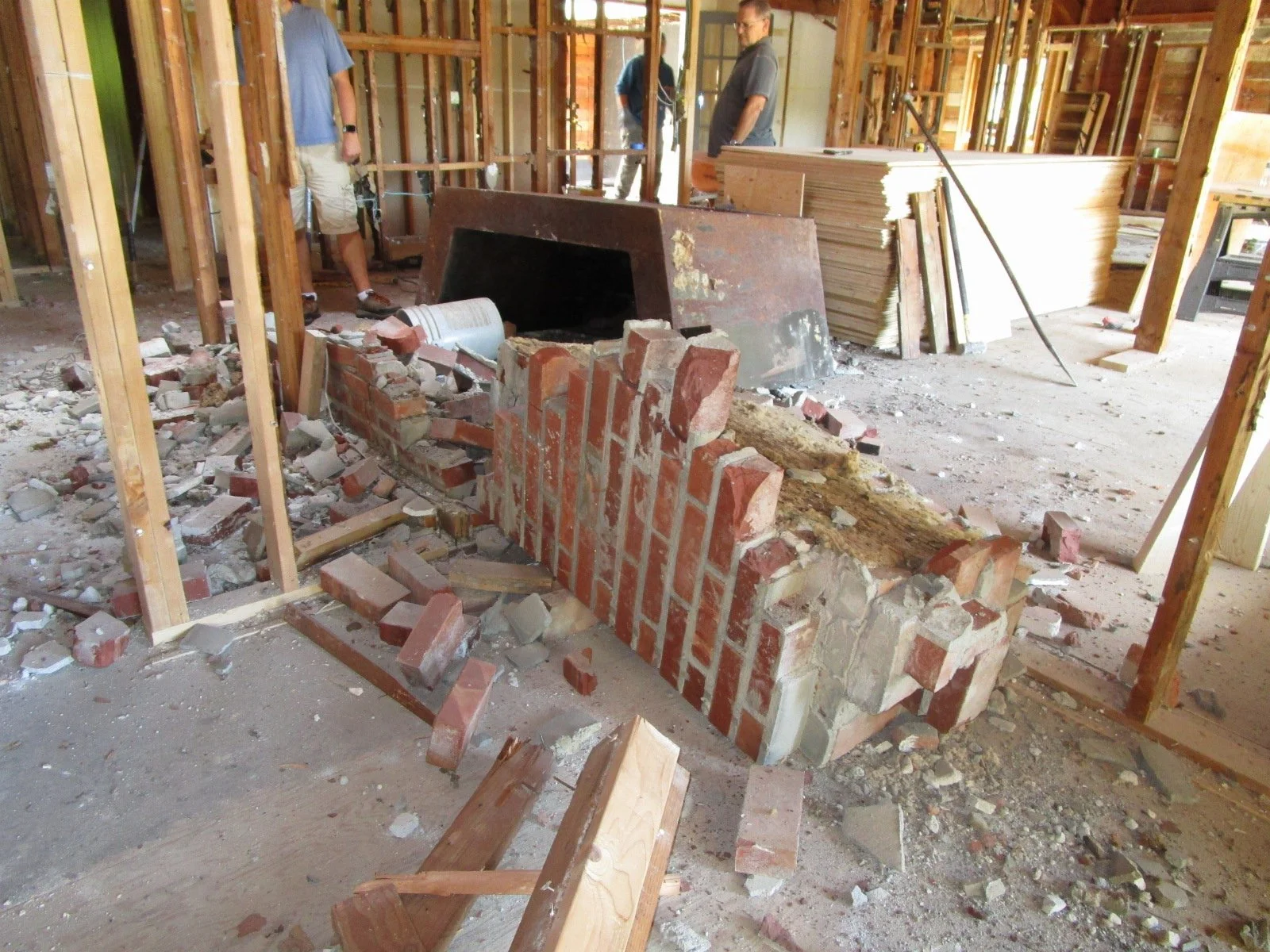 Another old brick fireplace bites the dust.
