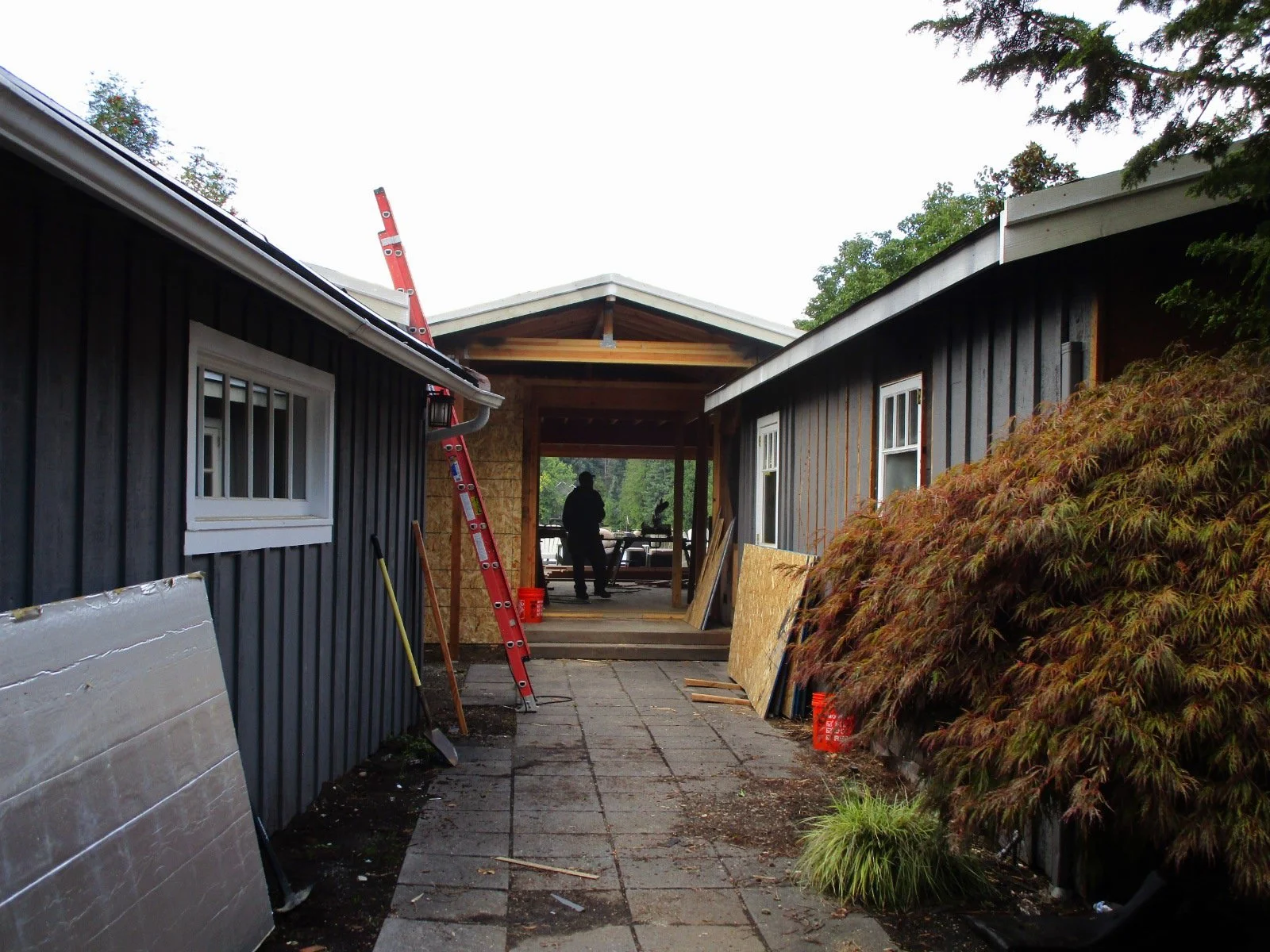 Stuffing a little nicer covered entry between the existing structures.