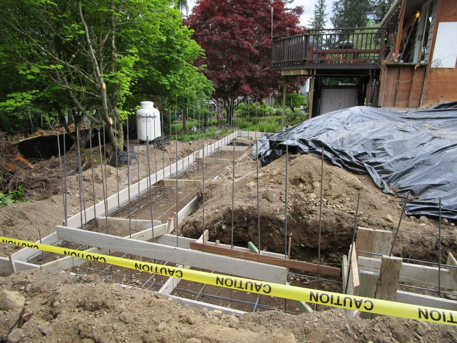 Rebar set for future concrete. There is a tall back wall to the new garage.
