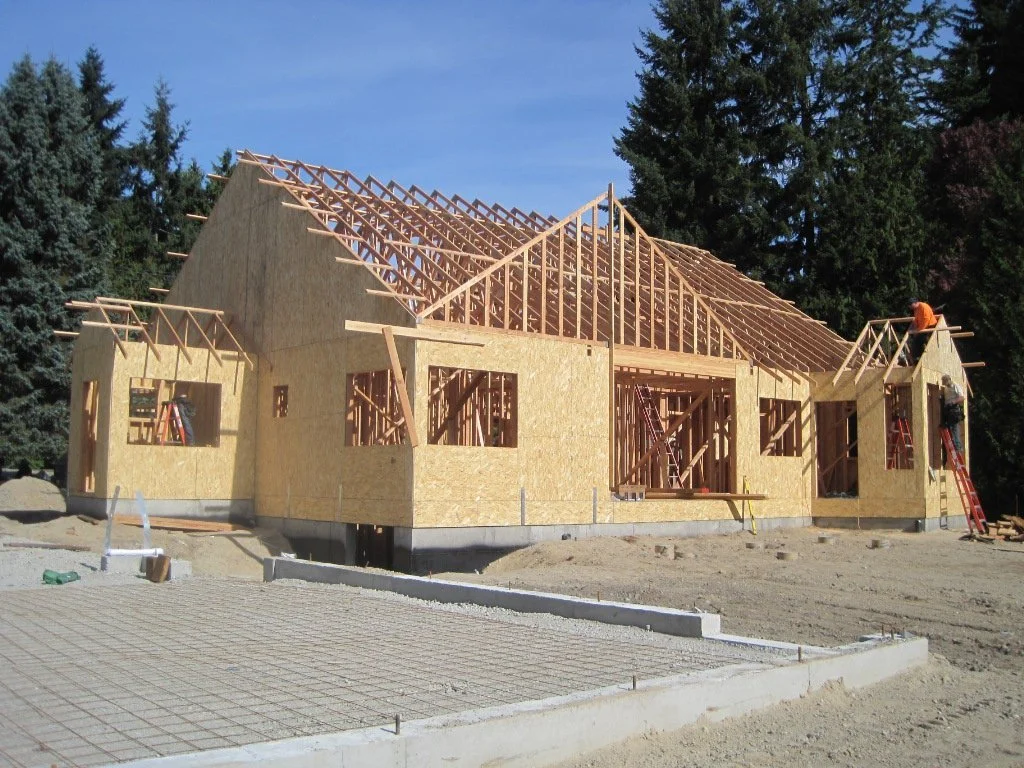 Main house well into framing. Foundation for DADU in the foreground.