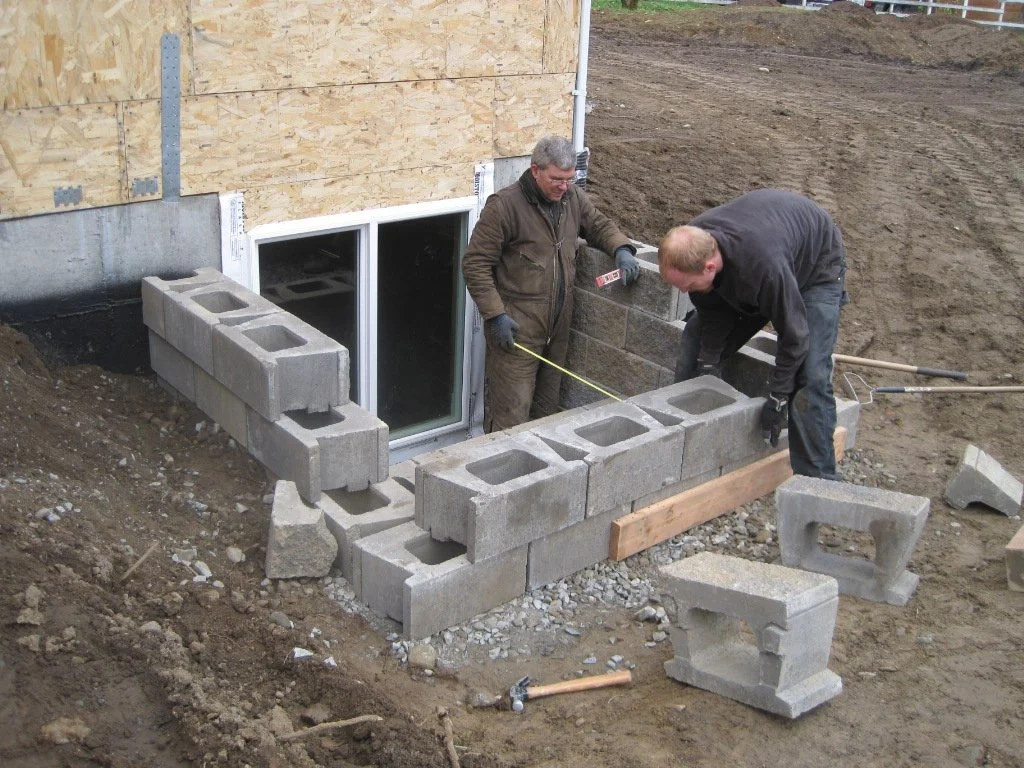 Creating the window wells for basement windows.