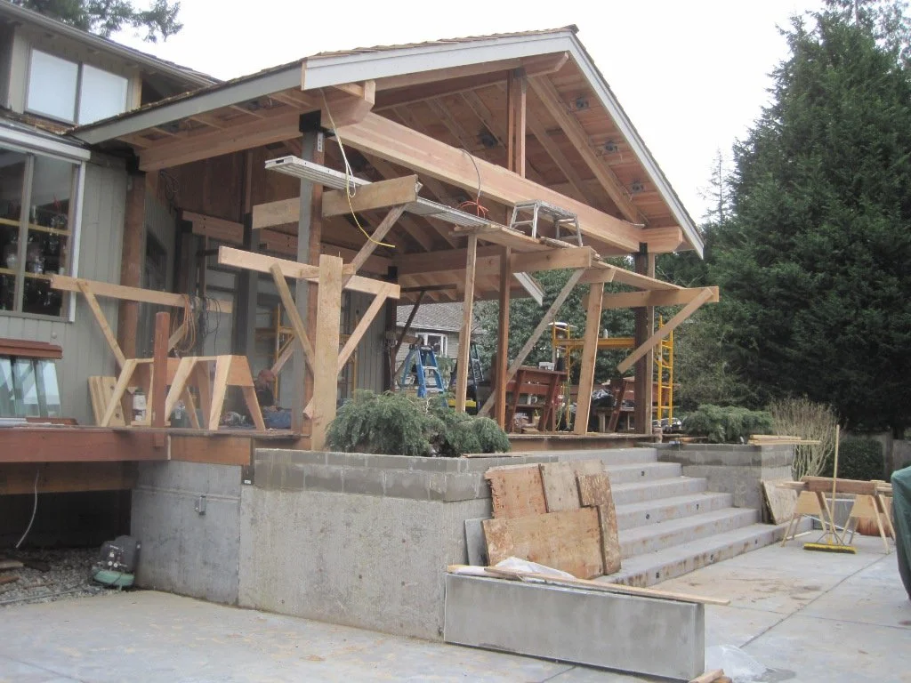 Framing continues, roof on.