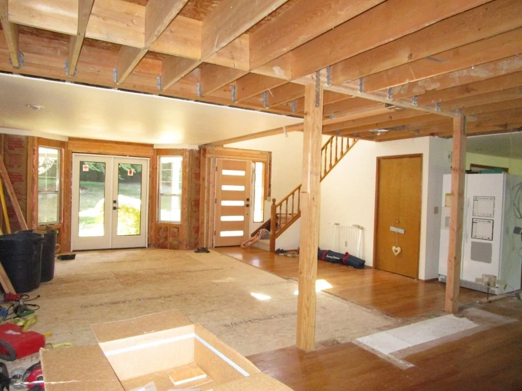 View from the kitchen area to the front of the house. The two columns are strategically placed to land in the future kitchen island.