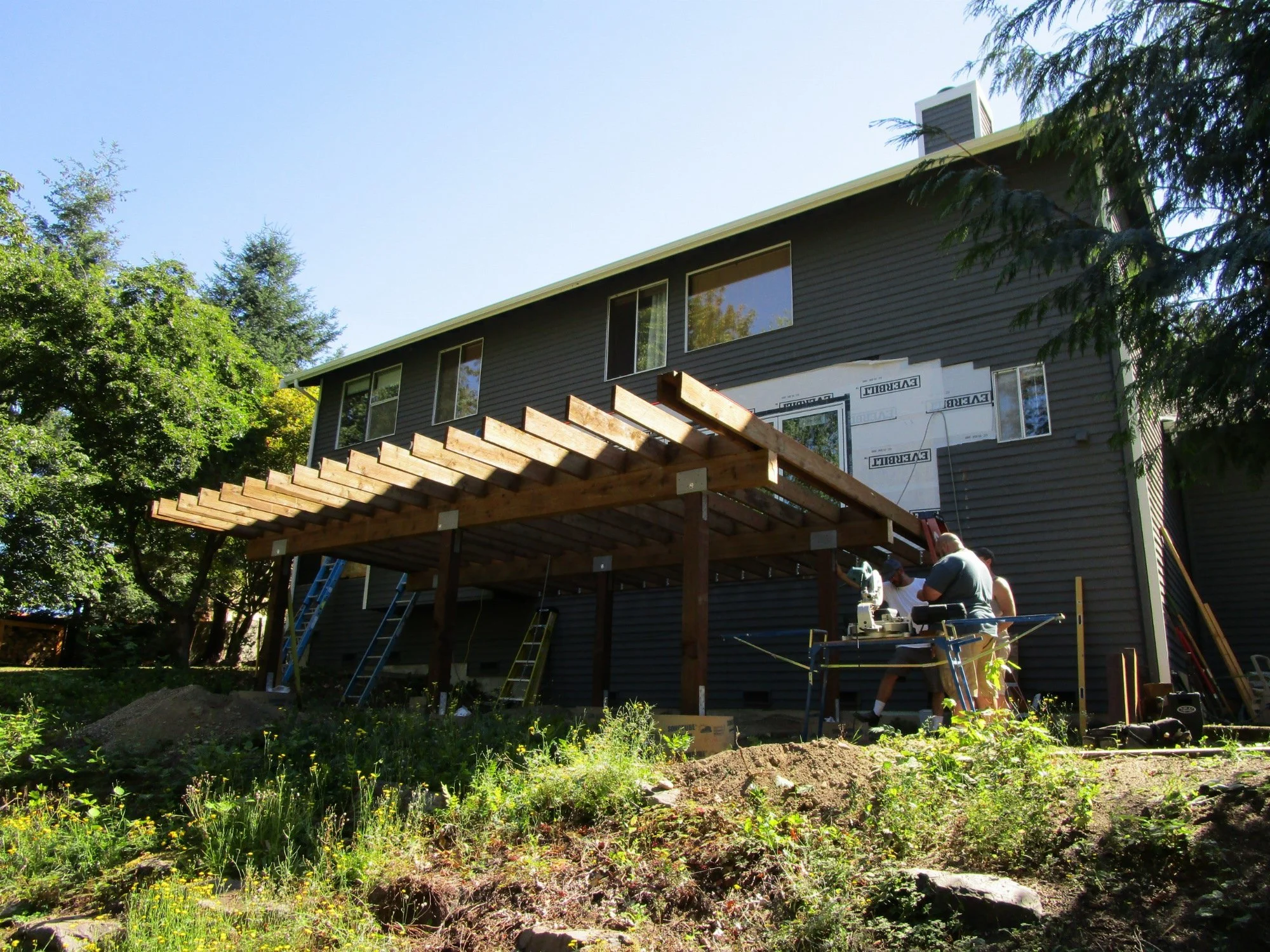 Outside, the old deck has been removed, new larger deck under construction. Nano wall just in view up there.