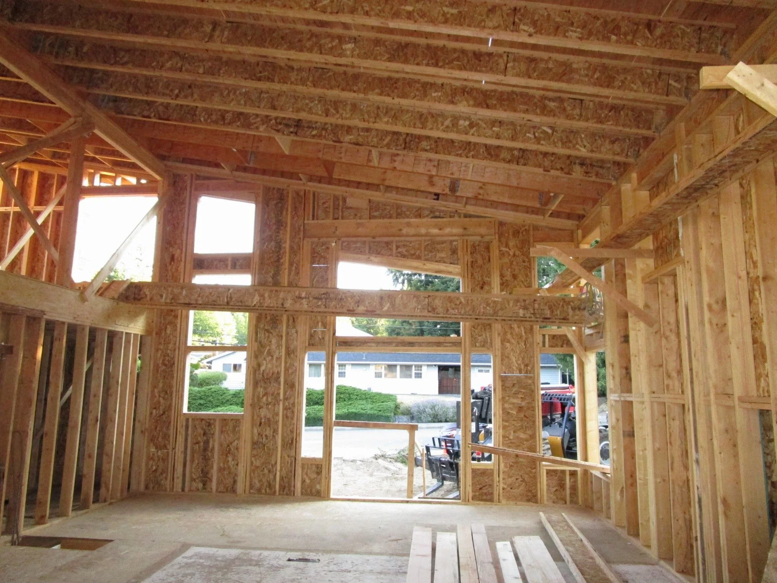 Looking from the kitchen to the front entry doors. Stairs will be on the left side wall.