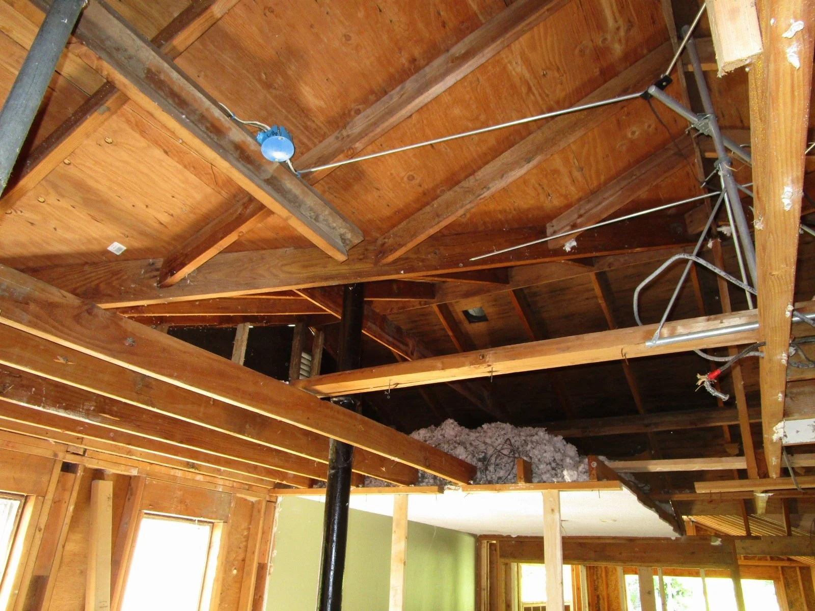 Removing some of the old roof framing in preparation for a big glu lam.