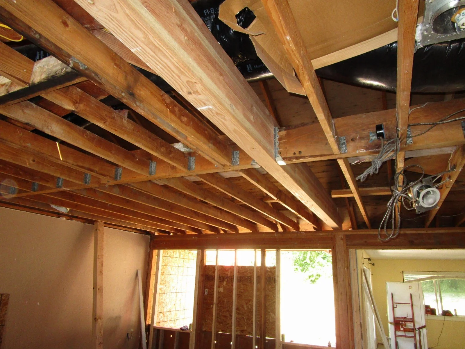 Big glu-lam set in place, lots of the roof sets and hangs from this beam. This allows the prior interior bearing walls to be removed.