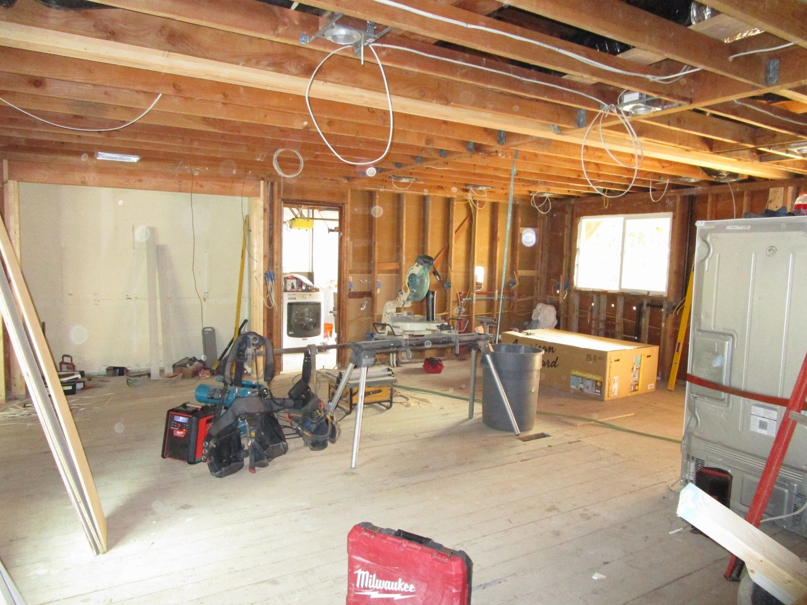 Looking towards the kitchen area. You can see the big glu-lam spanning this wide space.
