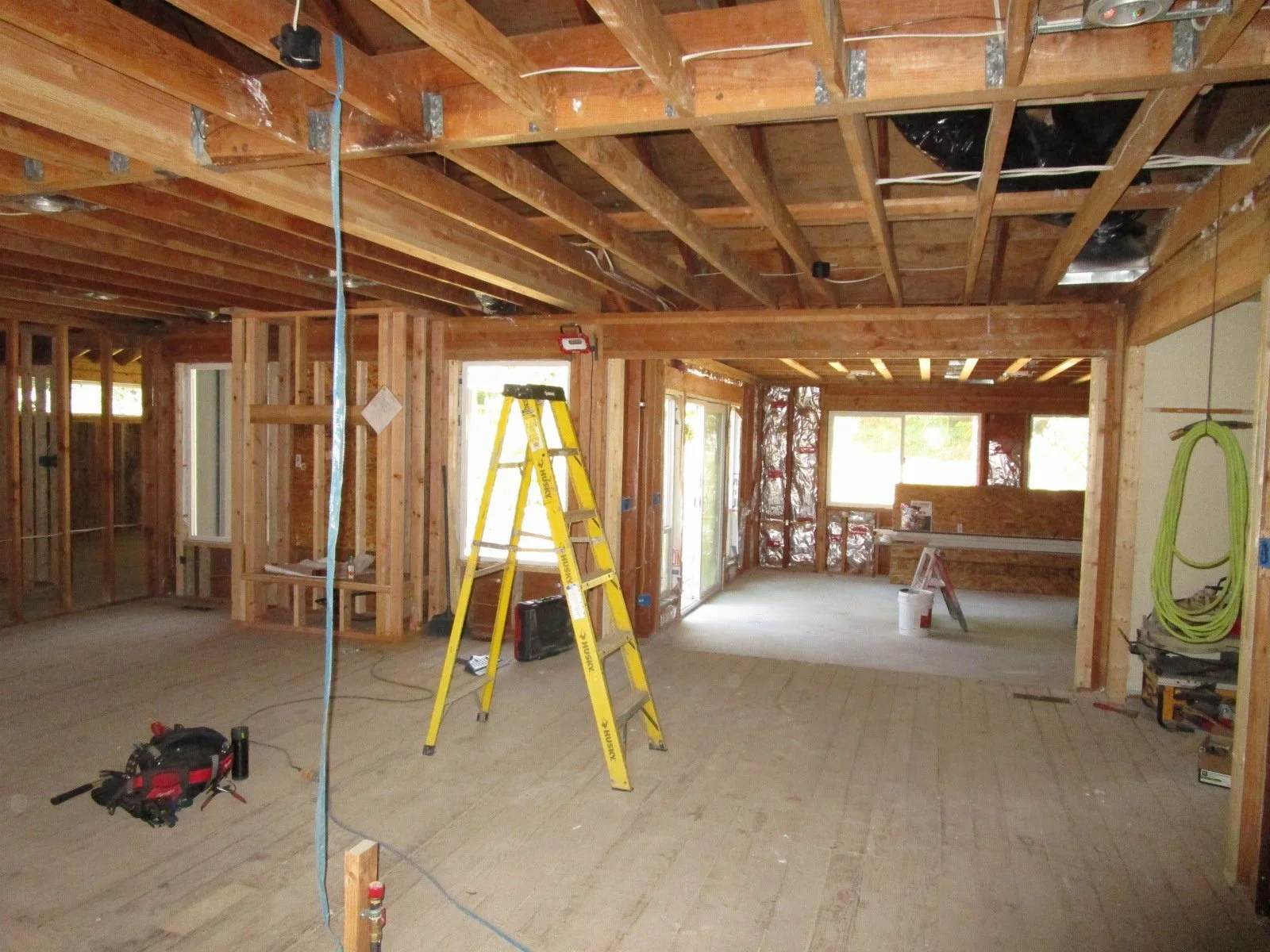 Beams hanging from beams to open this area up. View from the kitchen area.