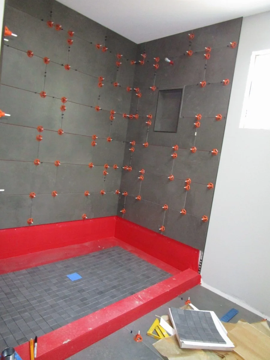 Setting tile in one of the new bathrooms.