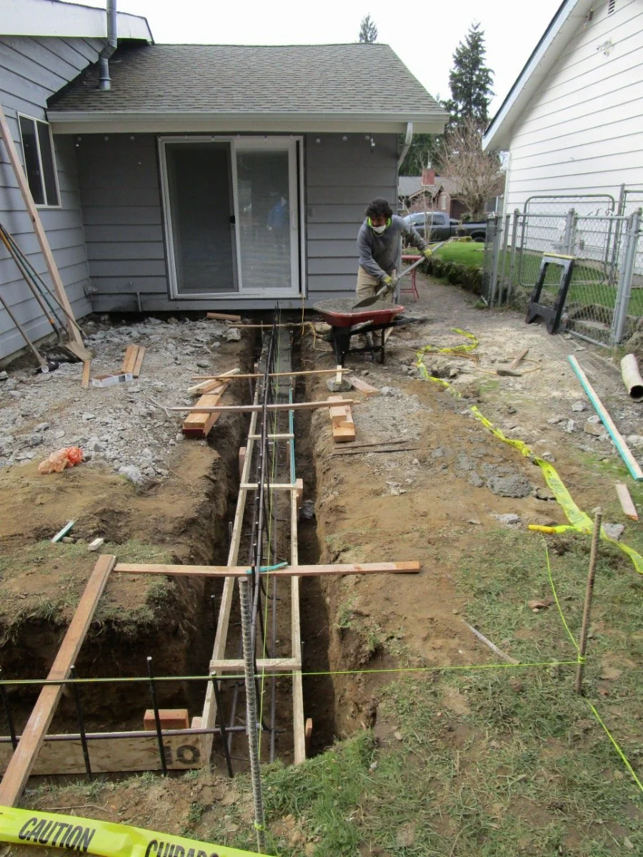Hand placing the cement into the formwork.