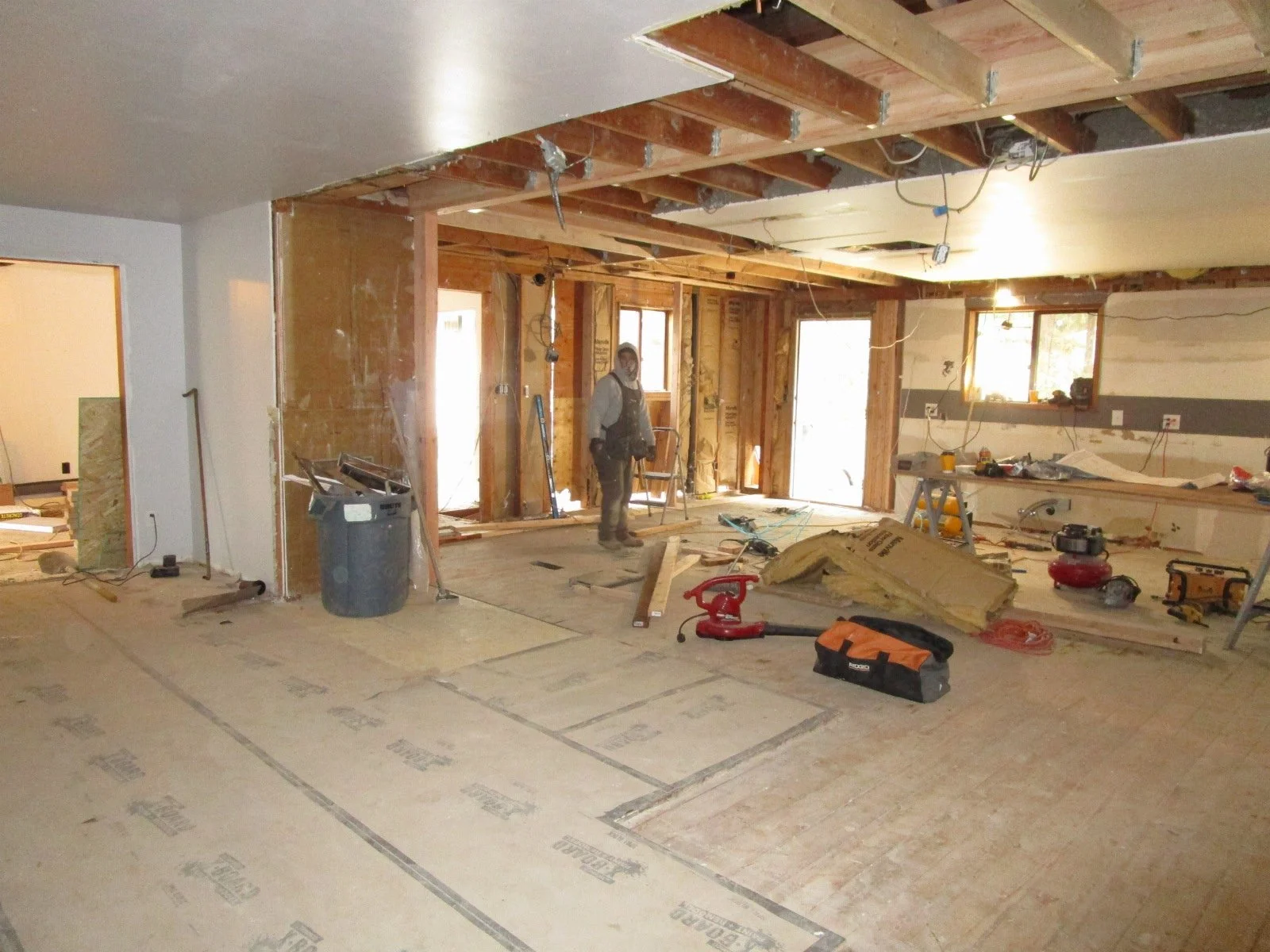 New glu-lam in place with existing ceiling joists hung from it.