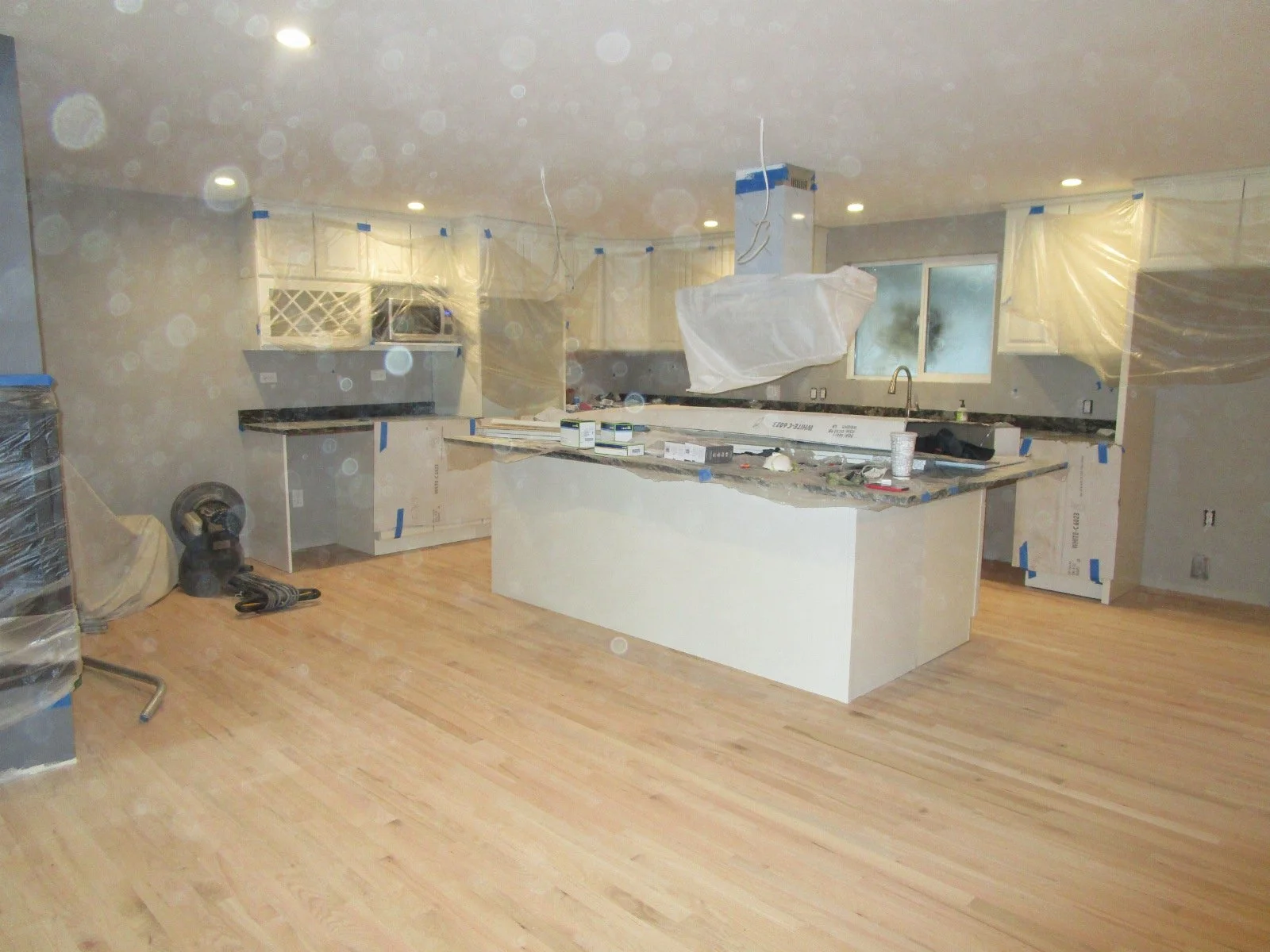 Fast forward and kitchen cabinets going in. Dust is from the new hardwoods.