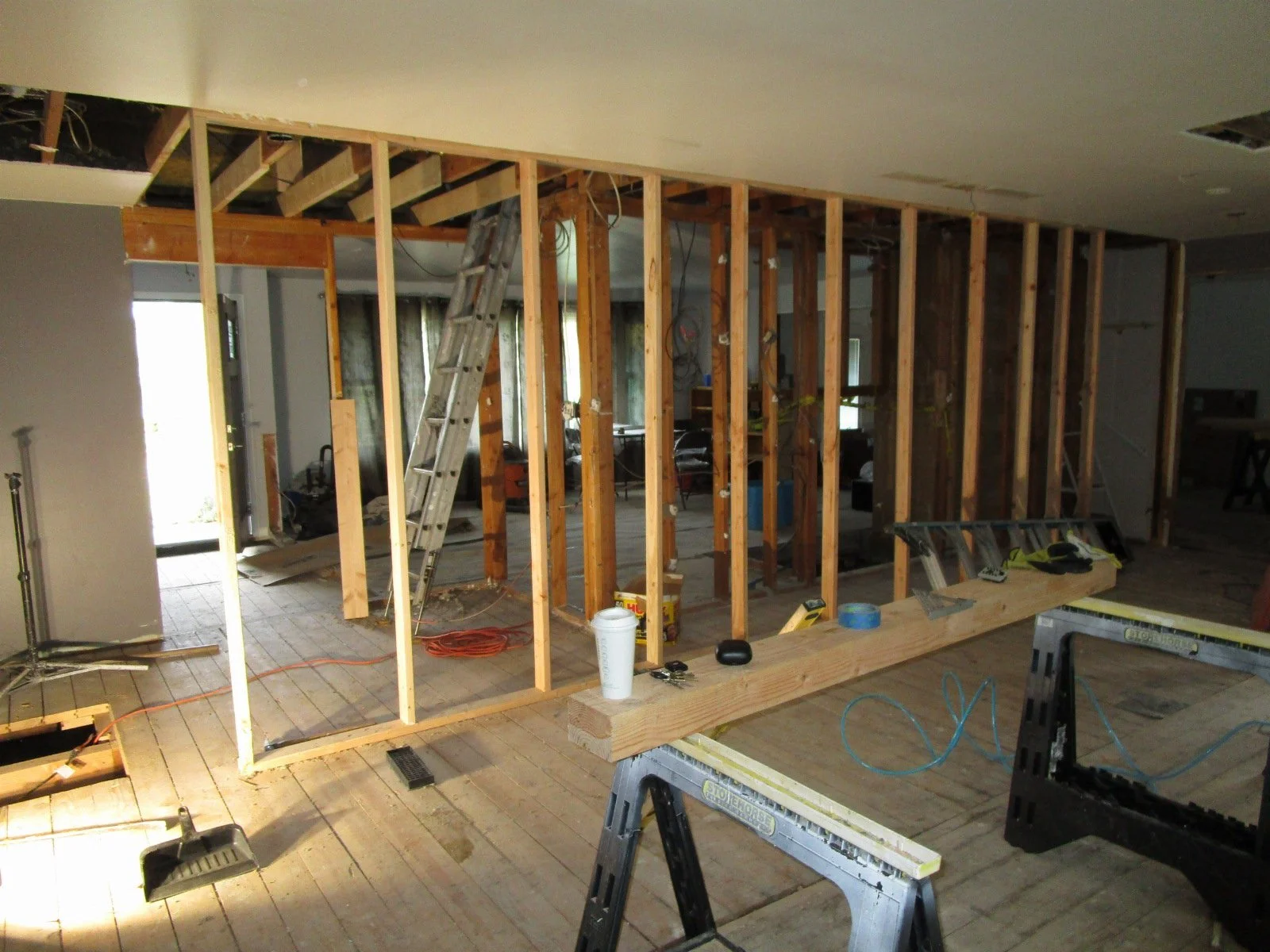 Temporary bearing wall in place so the new beams can be set in the ceiling to support the roof. Then the rest of the old bearing walls can be removed.
