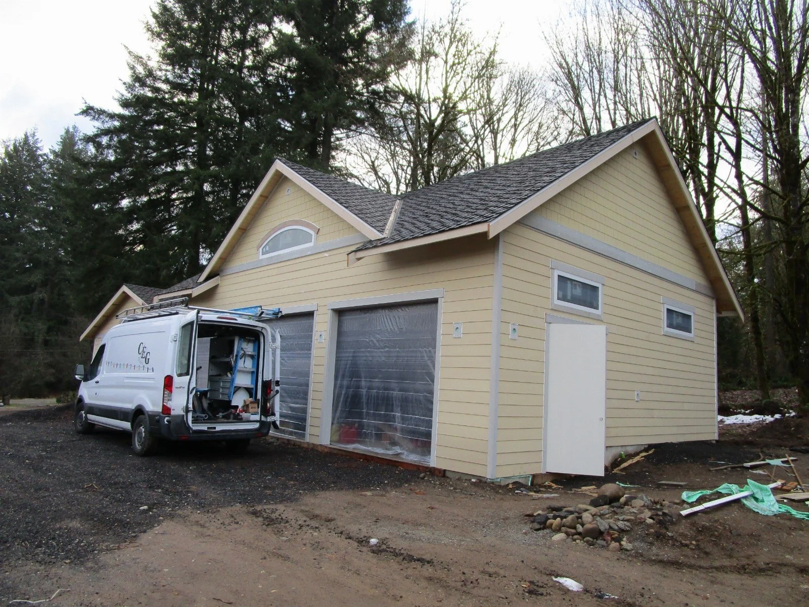 Siding and trim going on. Electrical work inside.