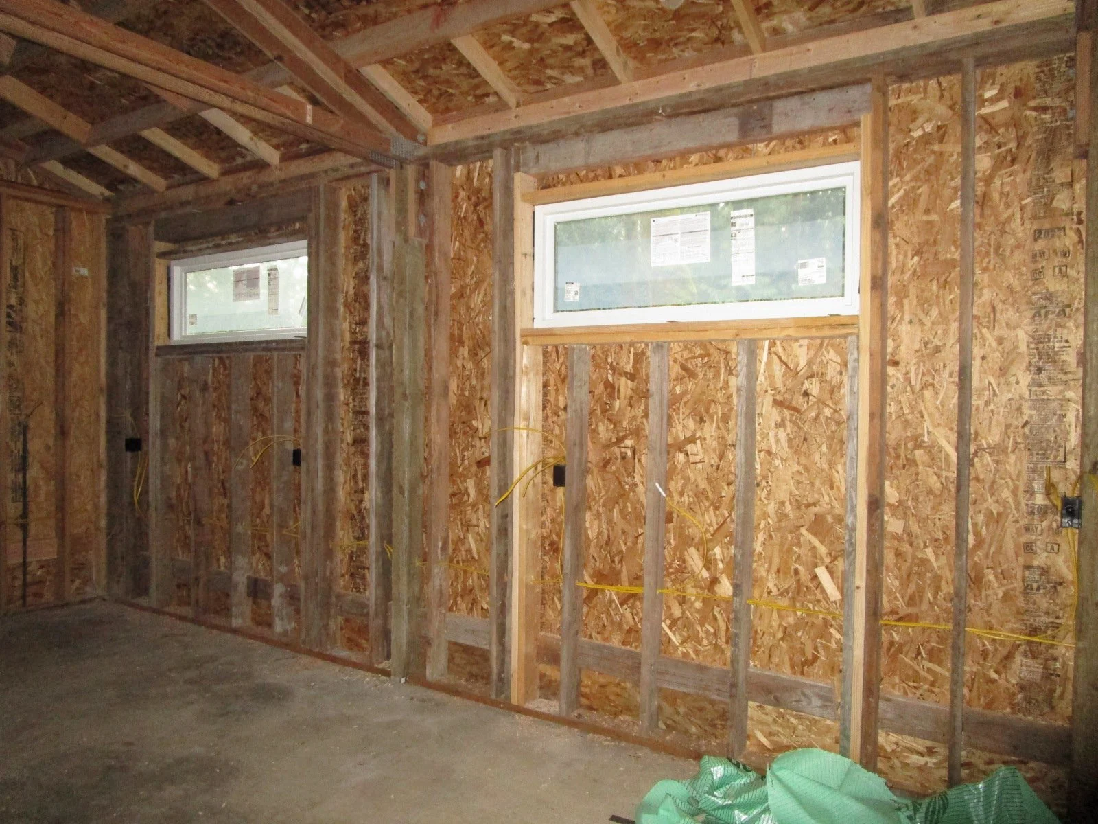New framed walls, plywood and windows in the old shop.