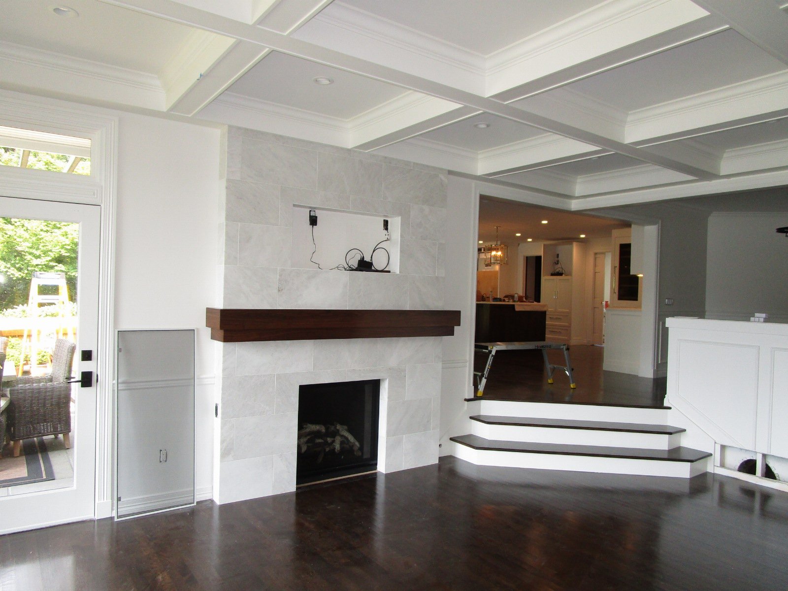 This fireplace was saved, and updated. There was an interior designer on this project who picked all the finish features.