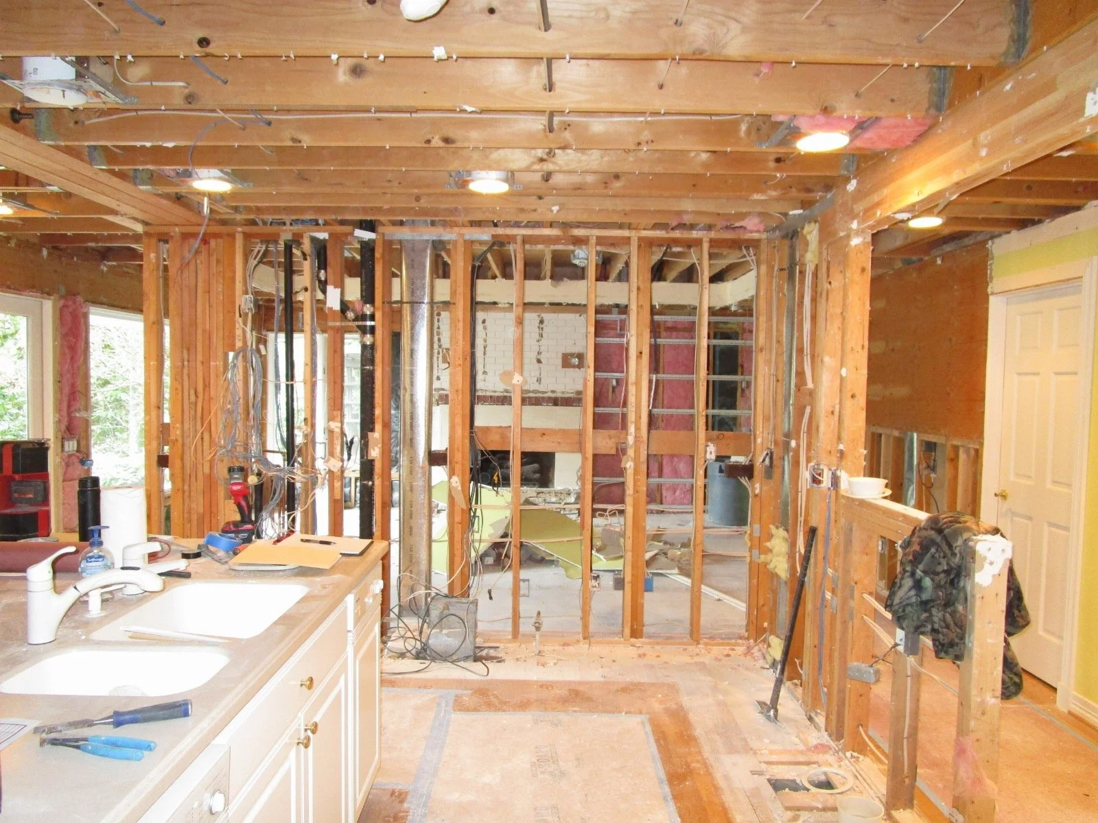 In the old kitchen, late decision to also remove the wall/beam on the right. Complicates the new beam layouts. And look at the long wall again, with all of the services in it. All of that has to find 