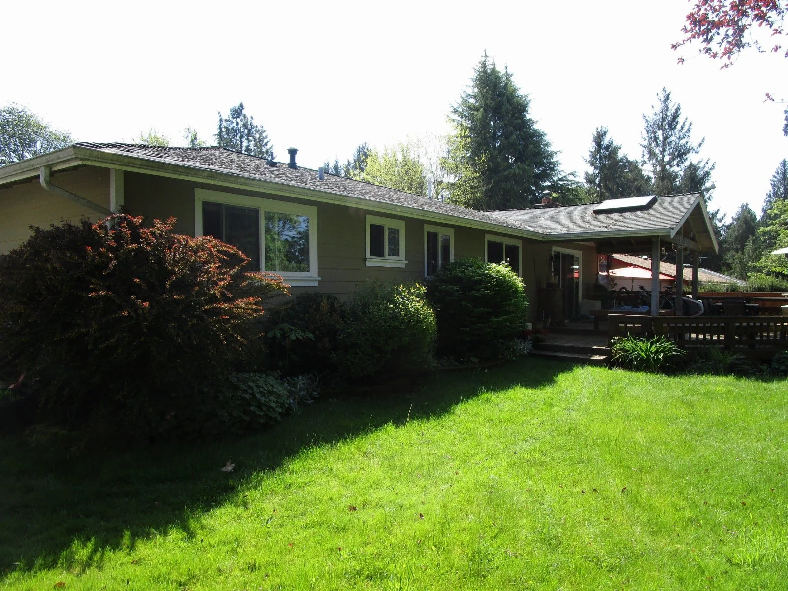 Back of house with old covered deck at the right.