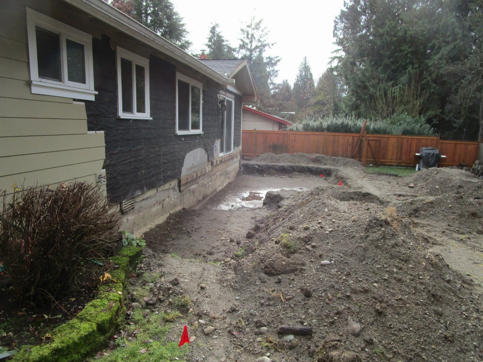 Old deck and roof gone, excavating for foundations.