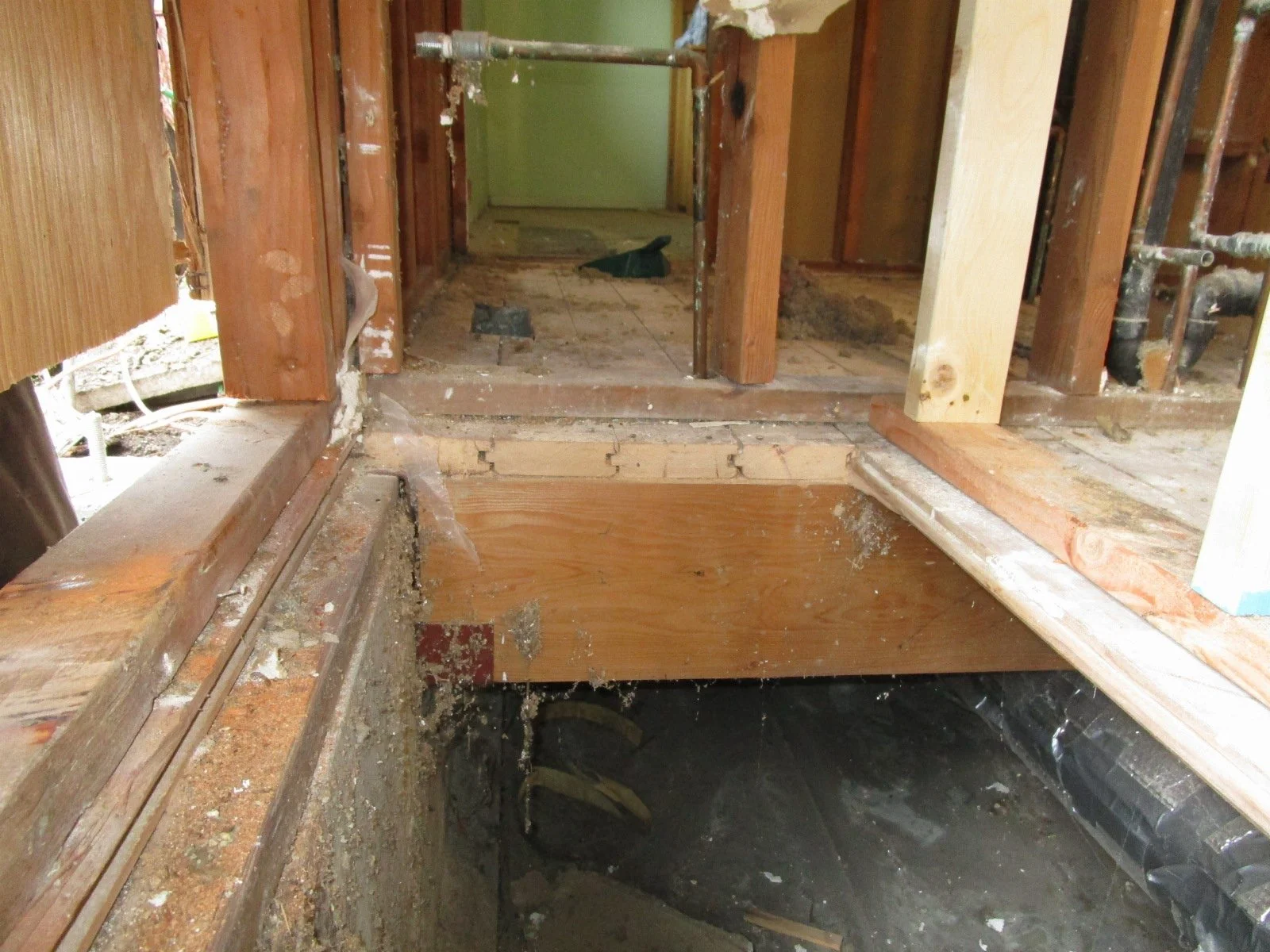Existing floor system is T&G car decking over floor beams. The T&G spans about 4 feet between beams. Now with things really exposed, we can see the floor has been sagging. So as we open up these rooms