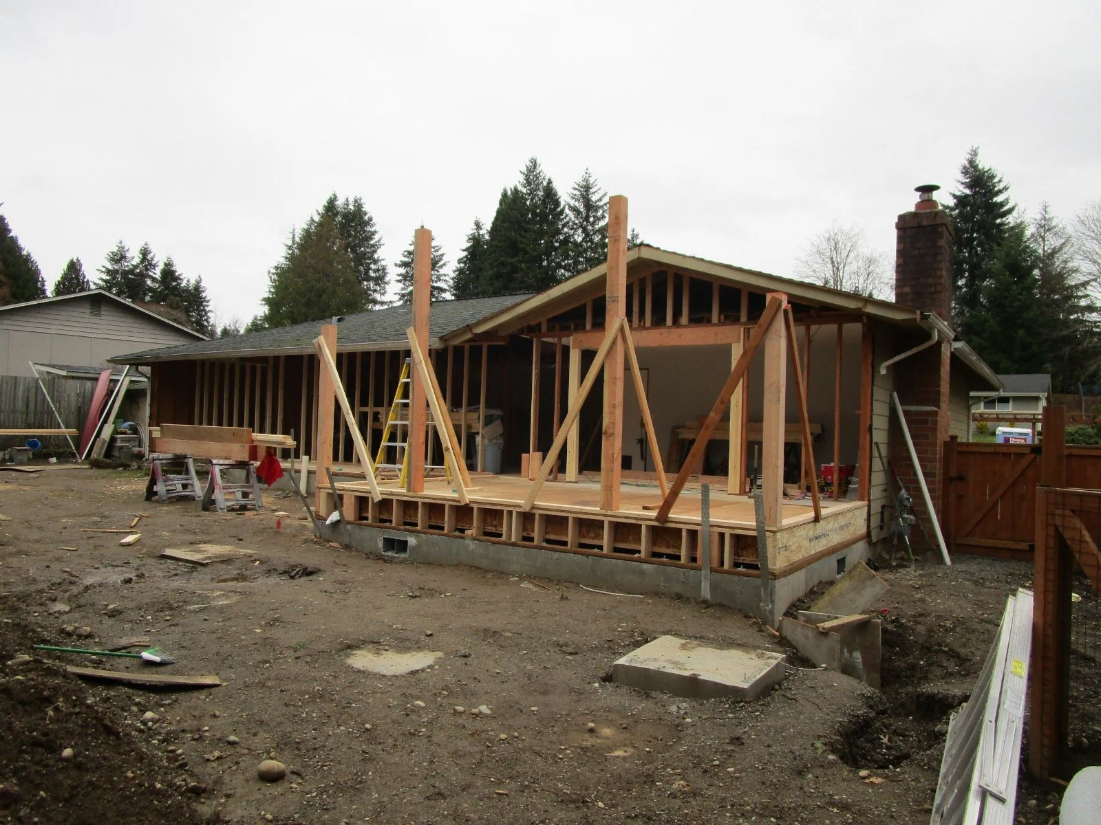 Eventually there will be a new covered deck in front of the Sun Room, with a seamless extension of the sun room roof over the deck.