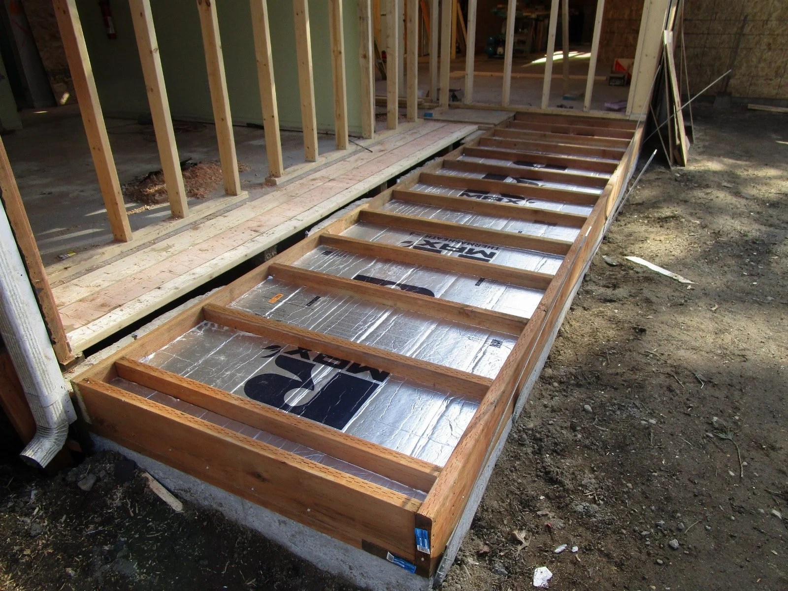 Concrete poured, filling the floor with rigid insulation to meet the energy code.