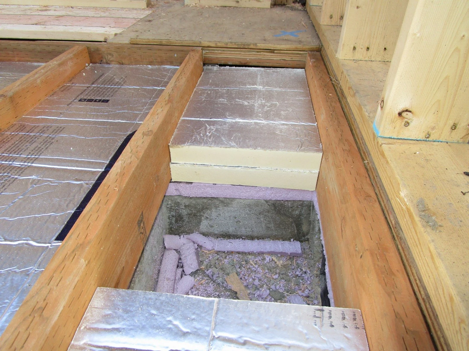 These floor cavities will get fully filled. A little time consuming to trim all of the rigid foam panels. Once filled fully, the plywood subfloor will go down.