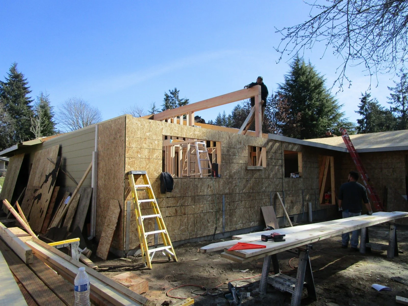 We've decided to go hipster modern and build a mono plane roof over this area, it can't be seen from the street. Top beam going in here.