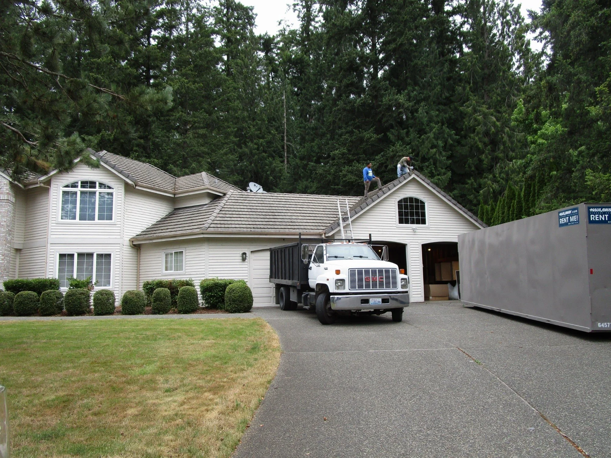 Workers pulling the first concrete roof tiles.