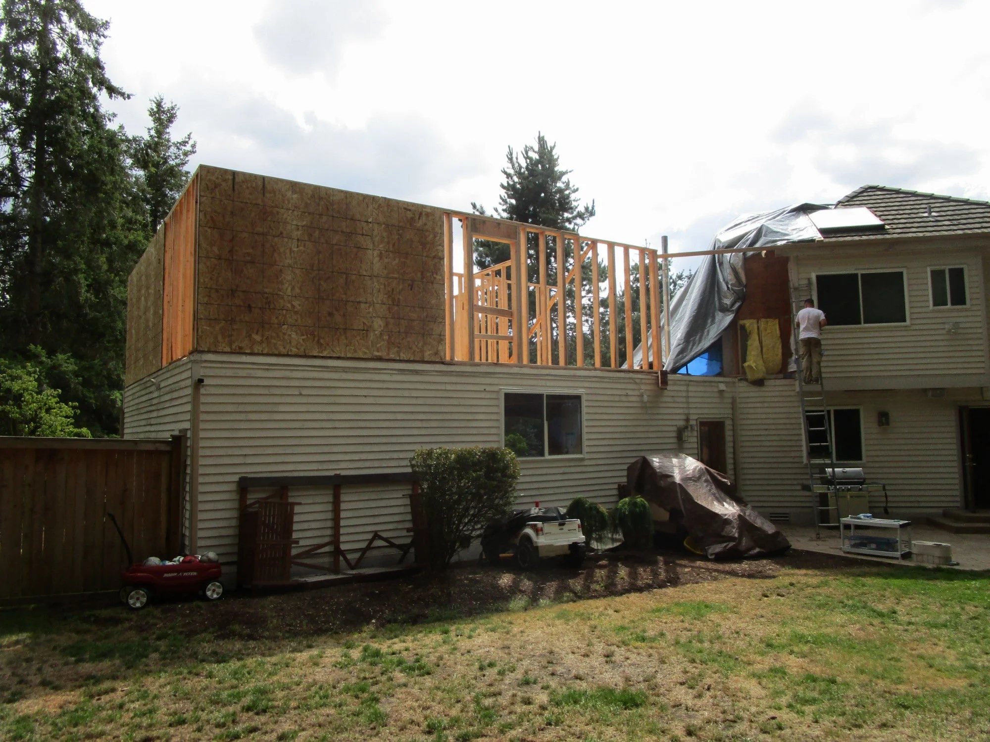 They are still doing some demo around the blue tarp as they blend the existing framing to the new framing.