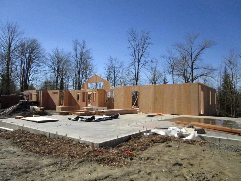Concrete pad is for the garage, pad to the right is for the music room.