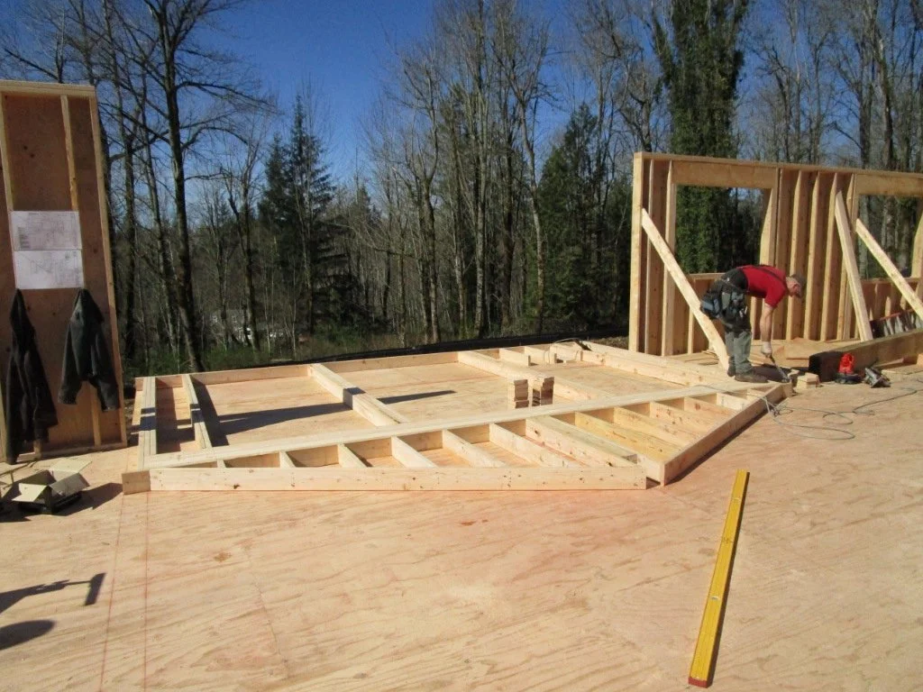Being framed on the ground, this is the North side tall wall yet to be lifted into place. It will lead to the covered deck.