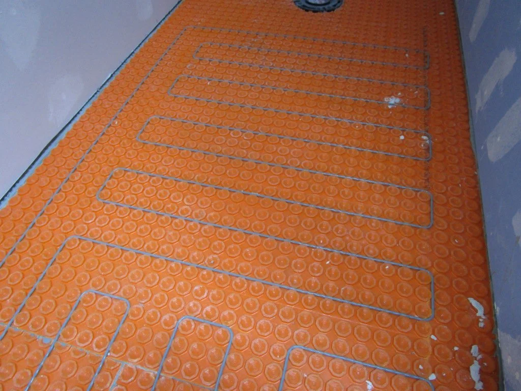 In the little toilet stall. Tile guy says this is the largest tile radiant heat installation he's ever done. I don't doubt it. Seemingly the only surfaces in the bath left to heat might be the ceiling