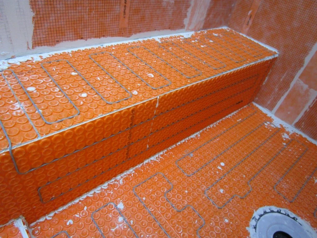 In the shower, this is the bench. When on, this system has about a 1300 watt draw. That's like a microwave running or a hair dryer on high.