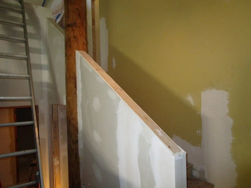 New straight run stairs. The homeowners are covering up a lot of rustic wood in this house. But, they are going to great lengths to leave this round peeled log in place. It was holding the treads of t